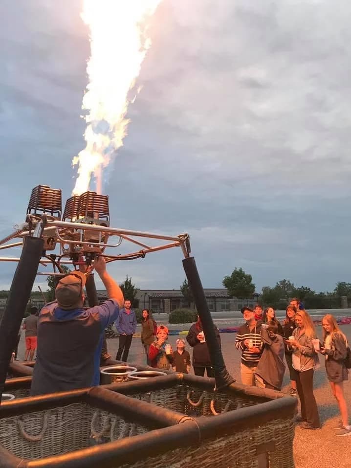Balloon burners firing above the basket as the crew prepares for flight